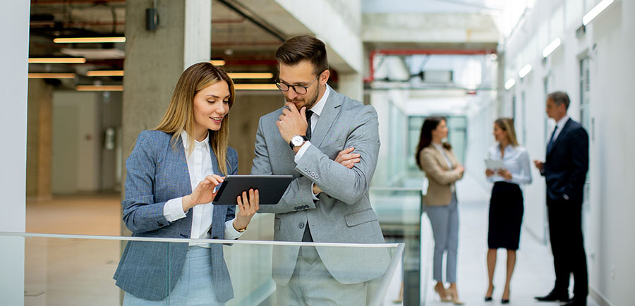 young-business-couple-holding-digital-tablet-discussing-company-strategy young-business-couple-holding-digital-tablet-discussing-company-strategy